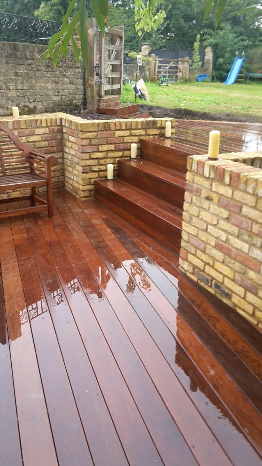 Hardwood decking with brick planters and candlelight