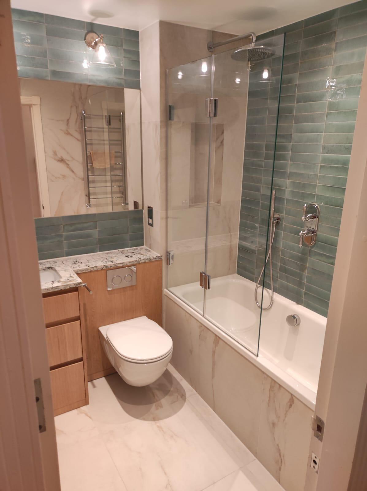Green tiled bathroom with marble panelling and chrome fittings